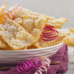 Rubrica “Alla Tavola di Hyria”: Chiacchiere di Carnevale (Chiacchiri di Carniali) Traditional sweet crisp pastry deep fried and sprinkled with powdered sugar. Carnival food tradition.